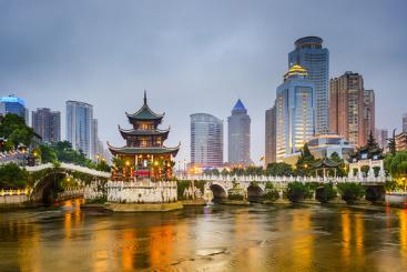 A bridge over water with buildings in the background.