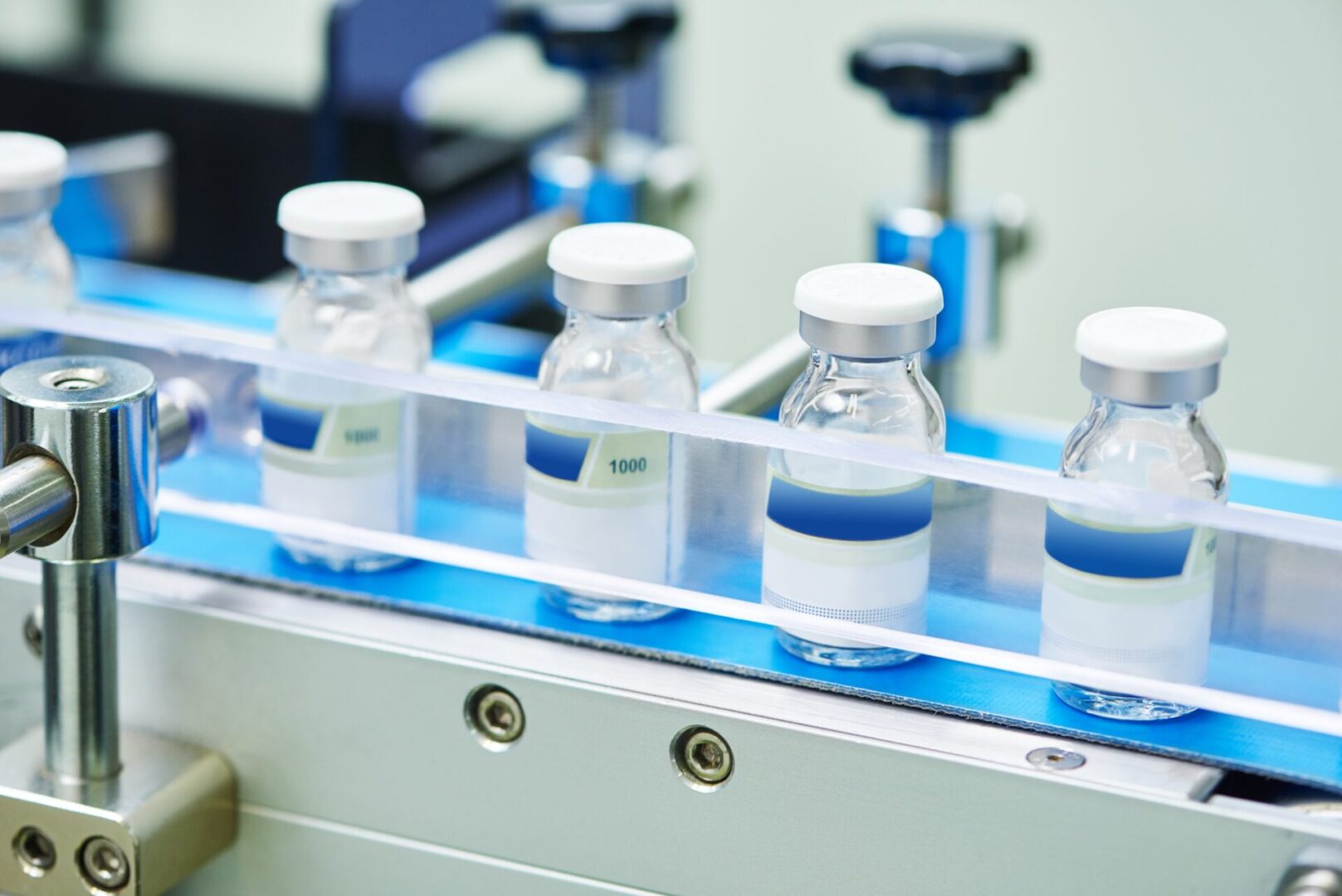 A group of bottles on top of a conveyor belt.