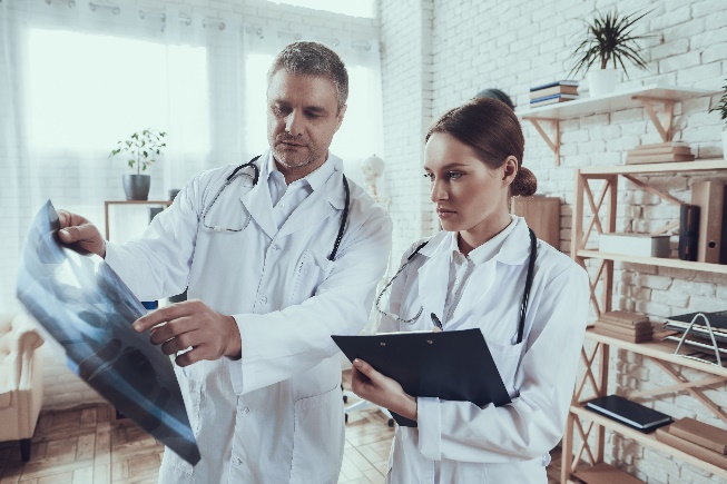 Two doctors looking at a xray in their office.