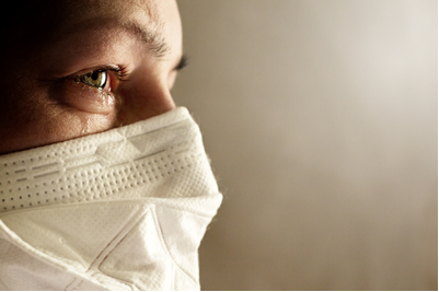 A person wearing a face mask and glasses