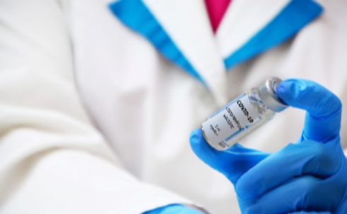 A person holding an injection in their hand.