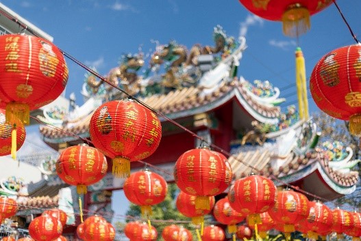 A group of red lanterns hanging in front of a building.