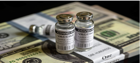 Two small bottles of vaccine sitting on top of a table.