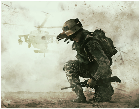 A soldier kneeling down in front of an helicopter.