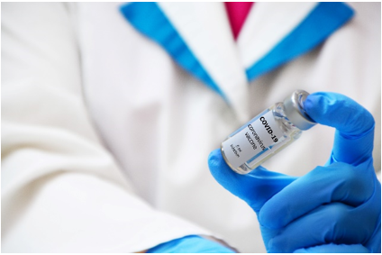 A person holding an injection in their hand.