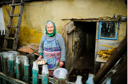 A woman standing in front of some milk cans