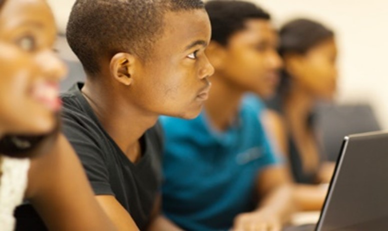 A group of young people sitting in front of each other.