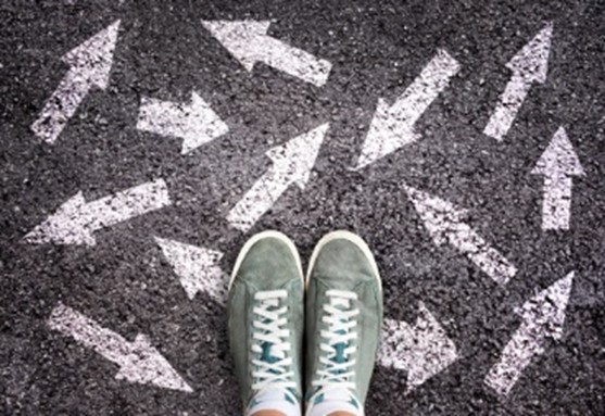 A person standing on the ground with many arrows