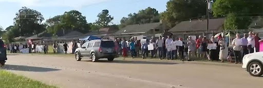 A group of people walking down the street