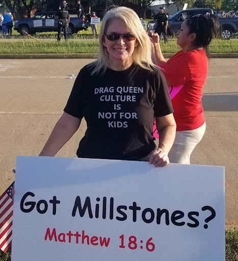 A woman holding up a sign that says " got millstones ?"