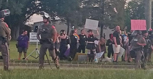 A group of people protesting in the grass.