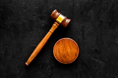 A wooden gavel and a small bowl on top of a table.