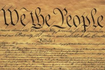 A picture of the constitution with the words " we the people " written on it.