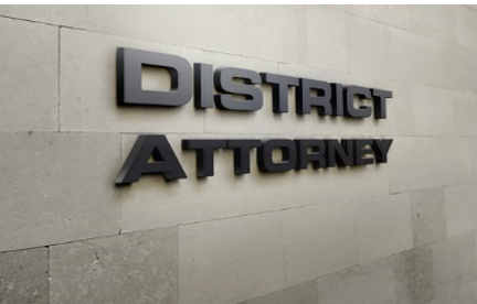 A sign that says district attorney on the side of a building.