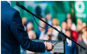 A man in a suit is giving a speech