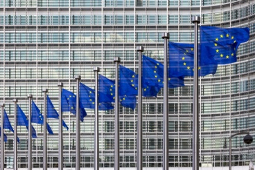 A row of flags in front of the european commission building.