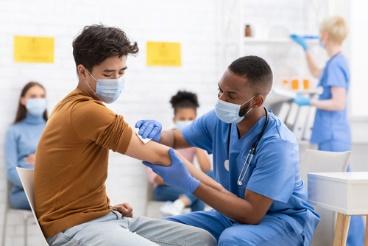 A doctor is helping someone with their medical gloves.