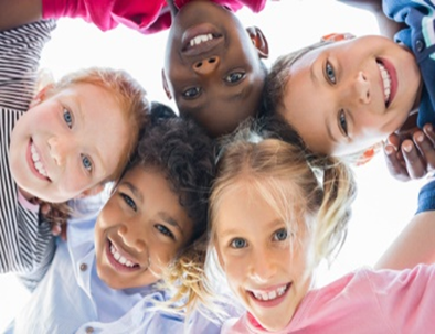 A group of children are smiling for the camera.