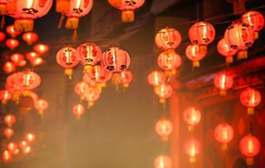 A bunch of red lanterns hanging from the ceiling