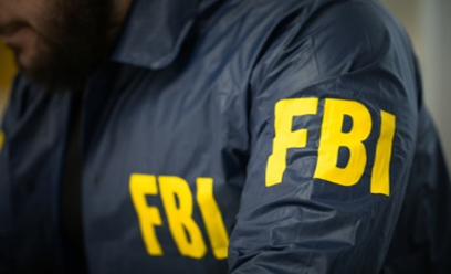 A person in fbi uniform with yellow letters on it.