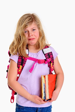 A little girl with a backpack and books in her hands.