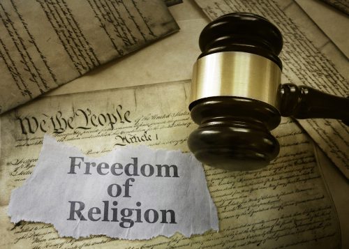 A judge 's gavel and the words " freedom of religion ".